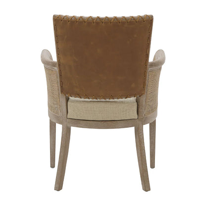 Poltrona con braccioli in canna e schienale in pelle cucita 