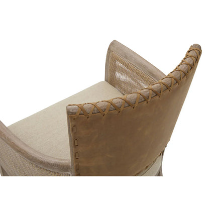 Poltrona con braccioli in canna e schienale in pelle cucita 